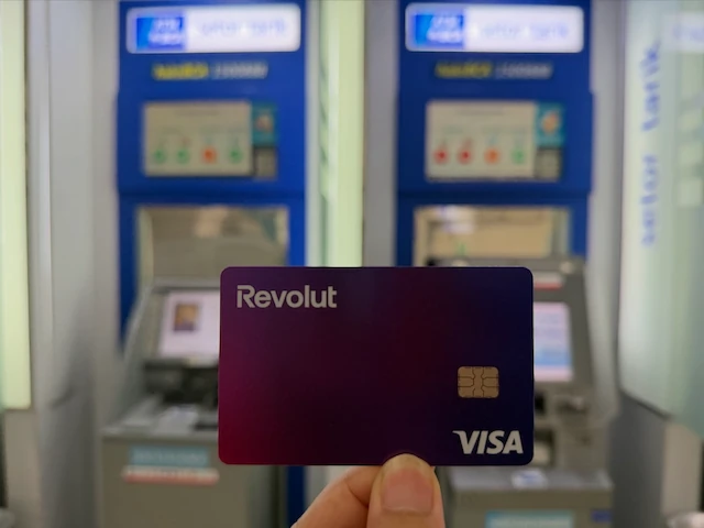 インドネシアのATMを背景にRevolutカードを持つ手元